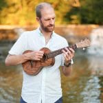 john allnutt playing a ukulele