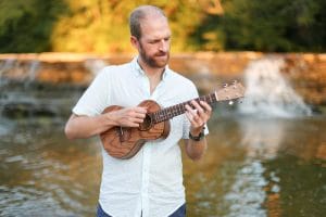 john allnutt playing a ukulele